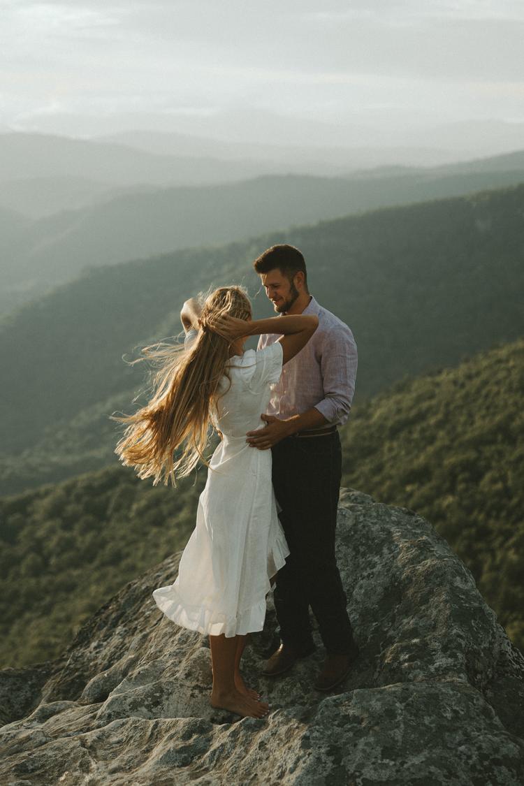 man and women embracing on mountain top