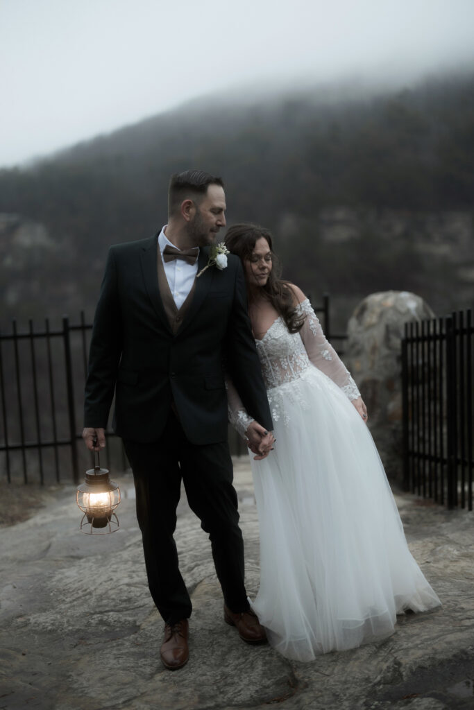 Bride and groom sharing a quiet moment in front of a waterfall during their Cloudland Canyon State Park elopement in winter