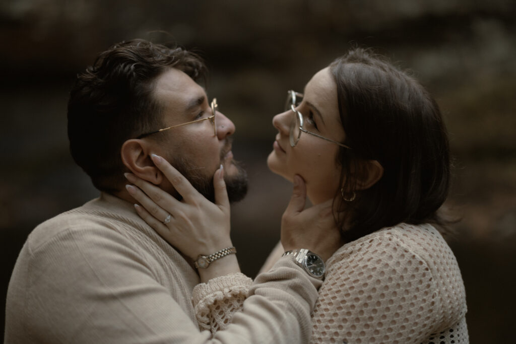 Couple embracing at a scenic overlook during their fall engagement session at Cloudland Canyon State Park.