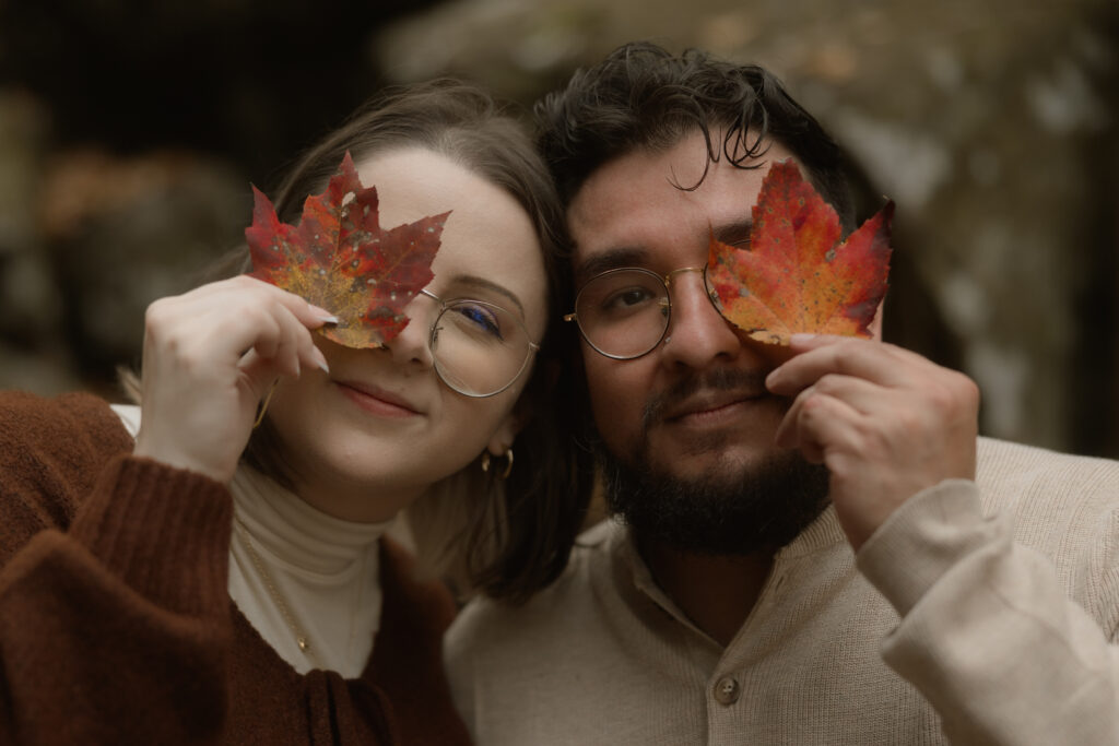 Couple embracing at a scenic overlook during their fall engagement session at Cloudland Canyon State Park.
