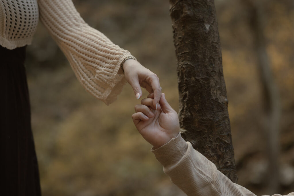 Couple embracing at a scenic overlook during their fall engagement session at Cloudland Canyon State Park.