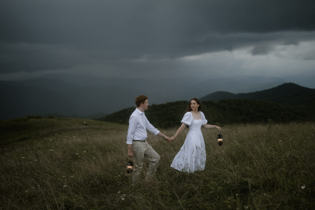 Couple embracing in a misty forest in Pisgah National Forest during a moody North Carolina mountain elopement.