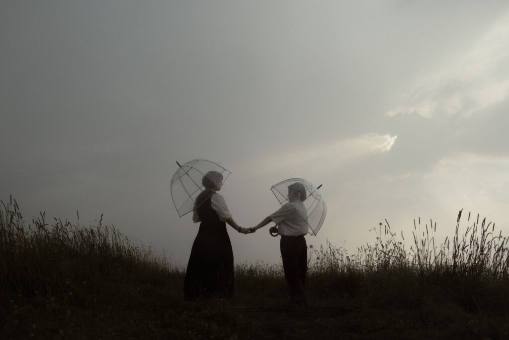 Couple during whimsical Asheville engagement session on Max Patch Western North Carolina mountain at sunset.