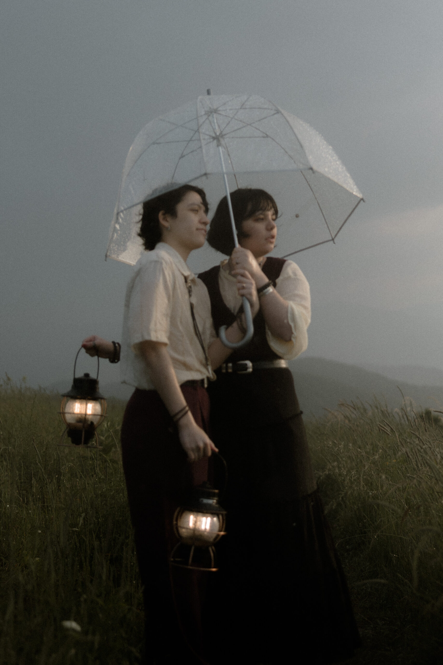 Couple during whimsical Asheville engagement session on Max Patch Western North Carolina mountain at sunset.