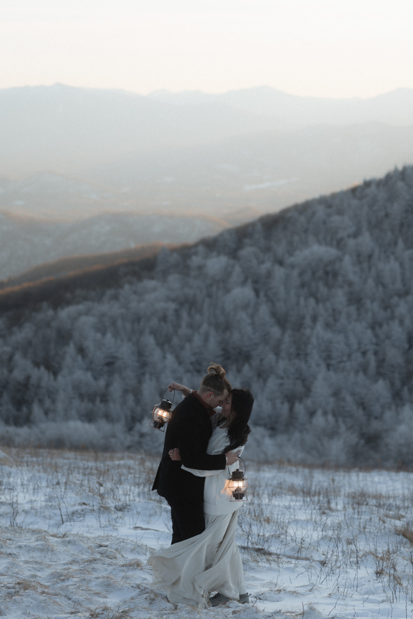 Bride and groom standing on a snowy overlook during a winter elopement on the Blue Ridge Parkway