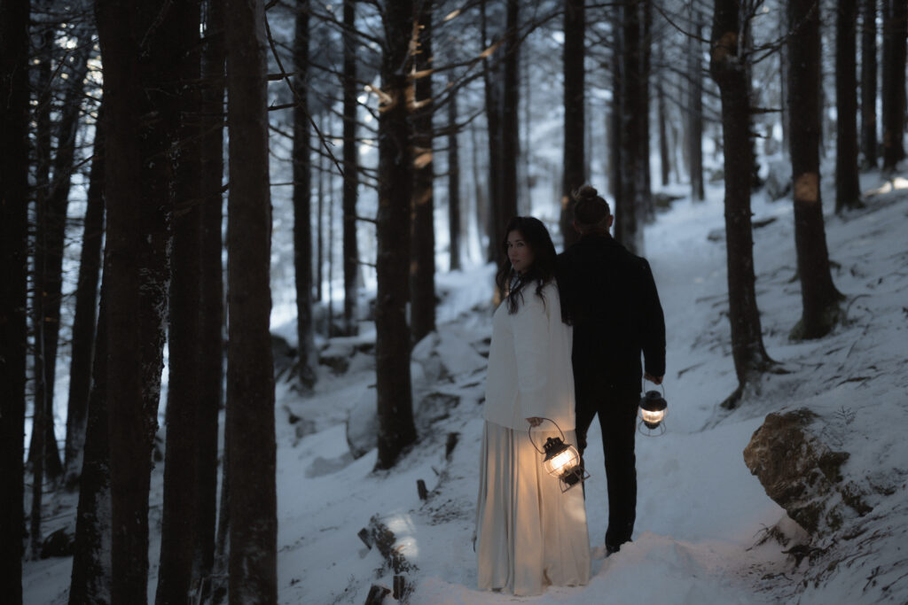 Bride and groom standing on a snowy overlook during a winter elopement on the Blue Ridge Parkway