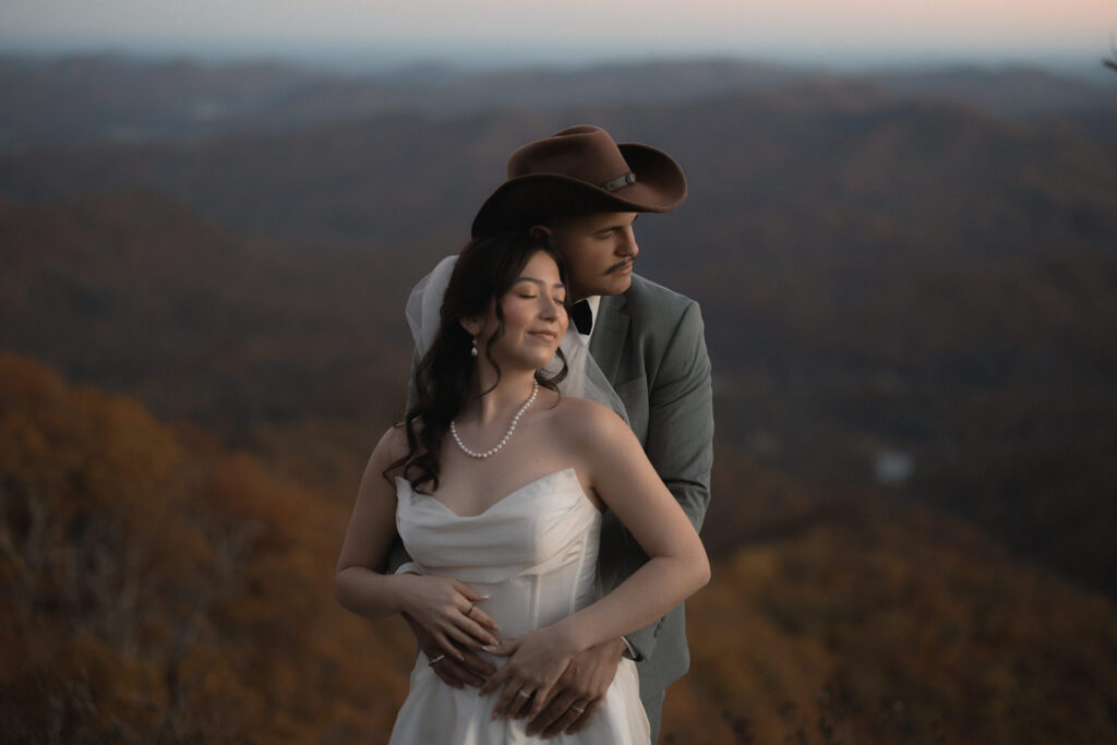 Golden hour portrait of couple during their October Asheville mountain elopement with fall foliage