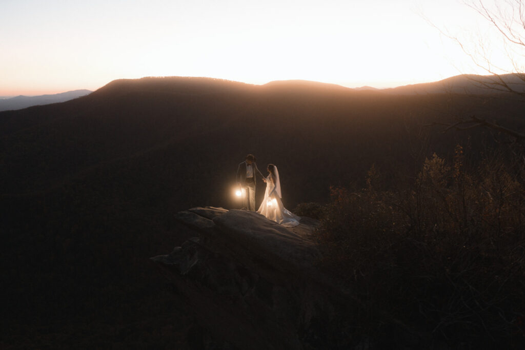 Newlyweds walking through colorful fall foliage during their October elopement in Asheville North Carolina