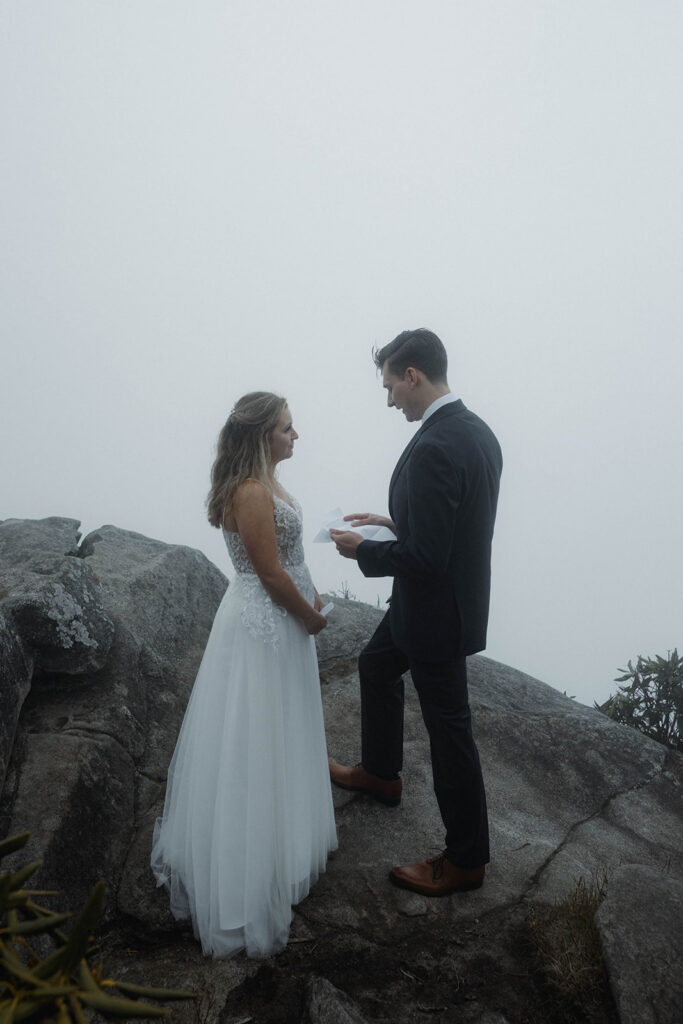 Cinematic portrait of couple in soft fog during an intimate Asheville mountain elopement ceremony