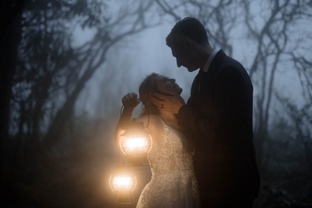 Bride and groom surrounded by thick mountain fog during their Blue Ridge Parkway elopement near Asheville