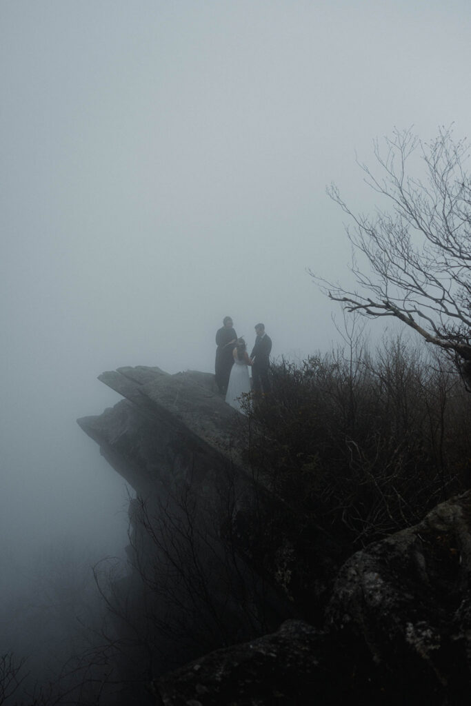 Cinematic portrait of couple in soft fog during an intimate Asheville mountain elopement ceremony