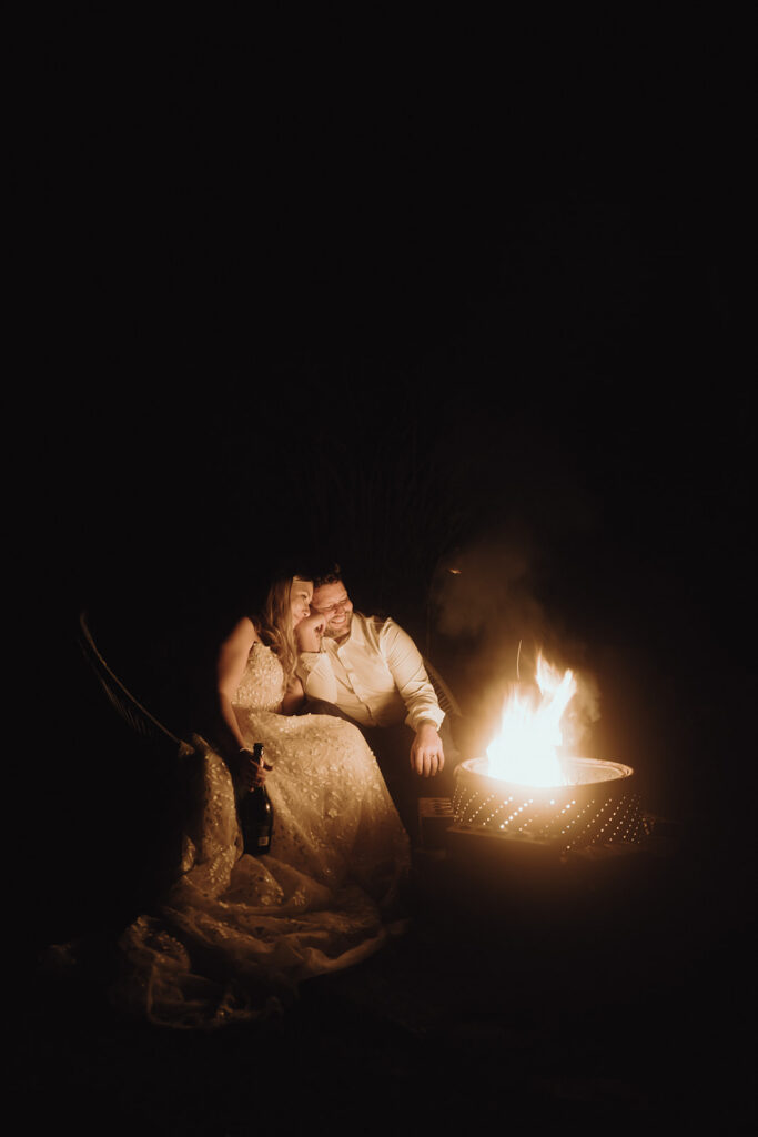 Bride and groom during their Asheville summer elopement on the Blue Ridge Parkway surrounded by a campfire