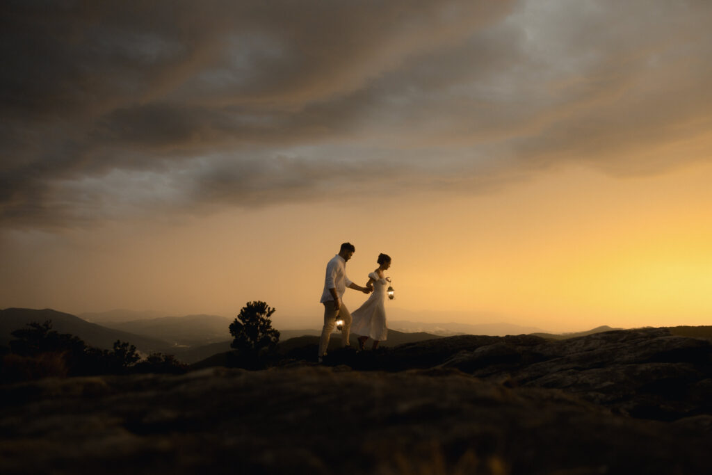 Couple standing on a foggy overlook during a rainy engagement session in Linville Gorge, North Carolina