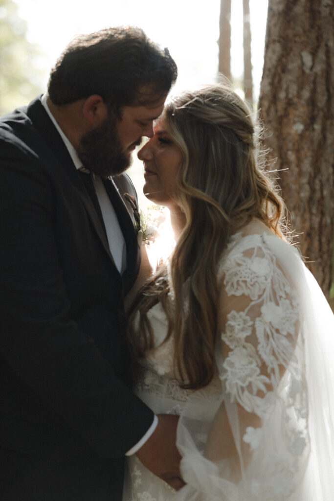 Couple exchanging vows beneath moss-covered trees in the Hoh Rain Forest during their Olympic National Park elopement.