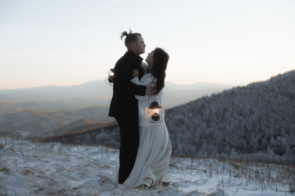 Bride and groom standing on a snowy overlook during a winter elopement on the Blue Ridge Parkway