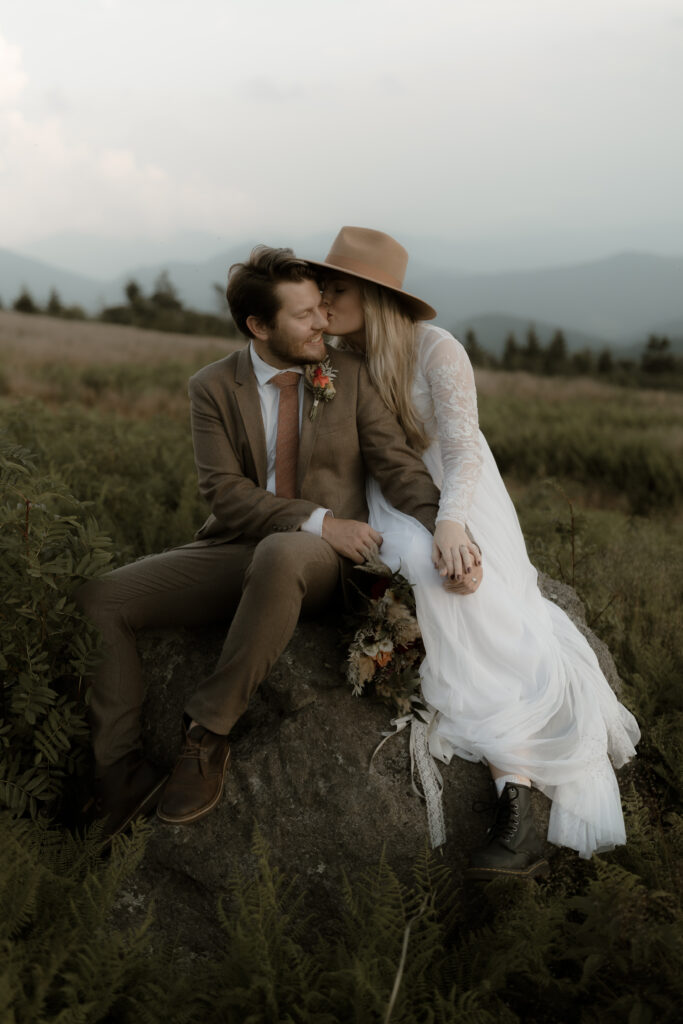 Bride and groom during their Asheville summer elopement on the Blue Ridge Parkway surrounded by vibrant greenery