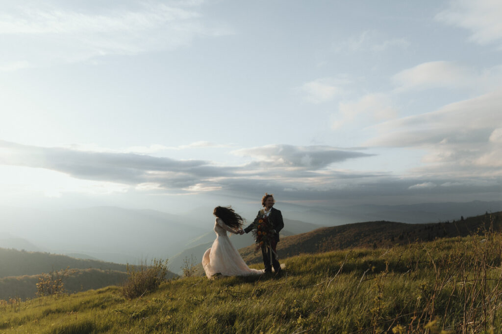 Bride and groom during their Asheville summer elopement on the Blue Ridge Parkway surrounded by vibrant greenery