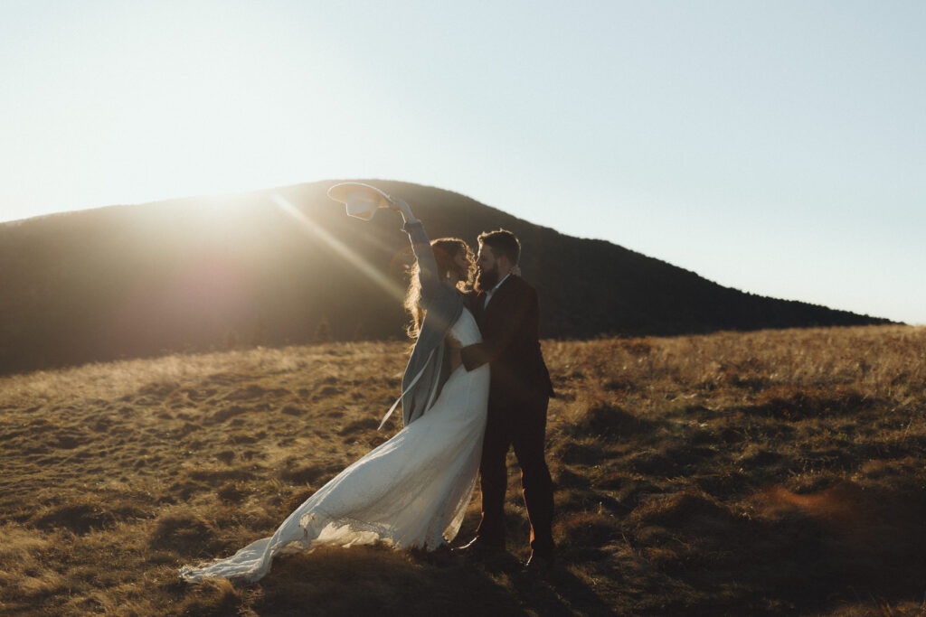 Golden hour portrait of couple during their October Asheville mountain elopement with fall foliage